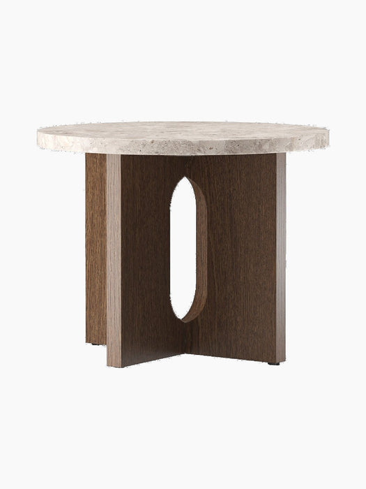Angled view of the Androgyne Side Table, Ø50, with a round Kunis Breccia stone top and a dark stained oak base with cutouts.