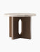 Angled view of the Androgyne Side Table, Ø50, with a round Kunis Breccia stone top and a dark stained oak base with cutouts.