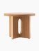 The Androgyne Side Table, Ø50, in natural oak, shown from an angle. It has a round top and a base with an oval cutout.