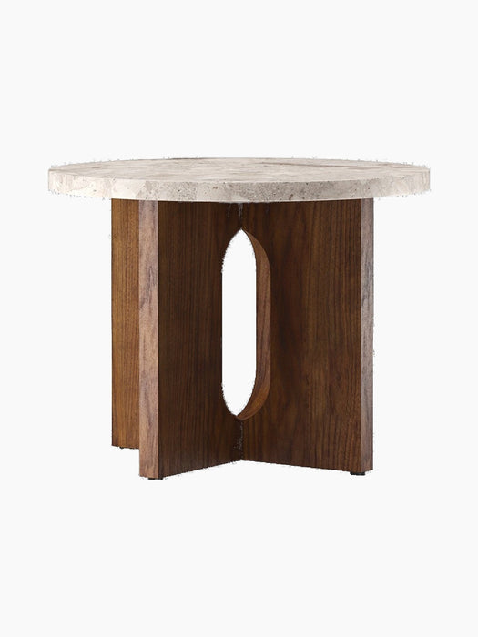 Angled studio shot of the Androgyne Side Table, Ø50, featuring a round Kunis Breccia stone top on a dark walnut veneer base.