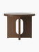 Back view of the Androgyne Side Table, Ø50, in dark stained oak, showing its round top and flat legs with an oval cutout.