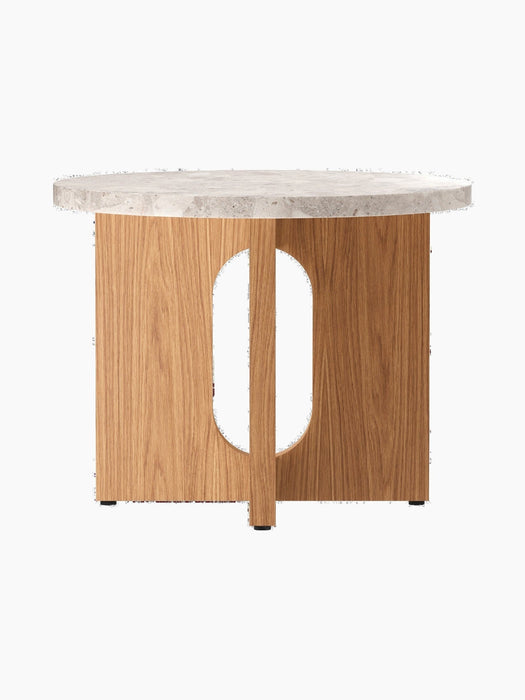 The Androgyne Side Table, Ø50, seen from the back, with a Kunis Breccia stone top and a natural oak base with an oval cutout.