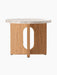The Androgyne Side Table, Ø50, seen from the back, with a Kunis Breccia stone top and a natural oak base with an oval cutout.