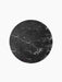 A top-down view of the circular Androgyne Side Tabletop in black Nero Marquina marble, showing its intricate white veining.