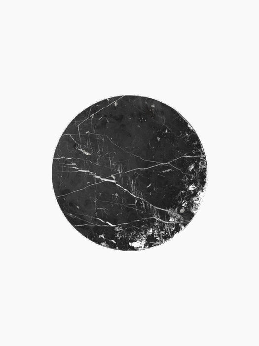 A top-down view of the circular black marble tabletop for the Androgyne Side Table, showing its intricate white veining.