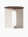 Front view of the Androgyne Side Table, featuring a round Emperador marble top and a sculptural ivory base with a cutout.