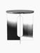 Front-facing studio shot of the black Androgyne Side Table, showing its round marble top and steel base with an oval cutout.
