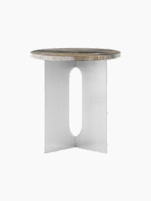 Angled view of the Androgyne Side Table with a Grey Galaxy marble top and a chrome steel base featuring an oblong cutout.