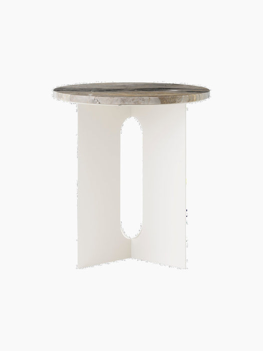 Androgyne Side Table with an ivory steel base featuring oblong cutouts, topped with a round Grey Galaxy marble slab.