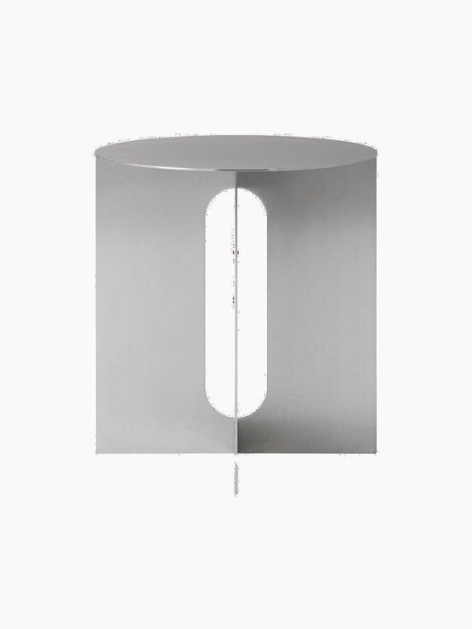Front view of the Androgyne Side Table, Ø40. The minimalist table has a silver steel base with a central oval cutout.