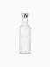 A front-view, studio shot of the Audo Bottle Carafe with Steel Lid. The minimalist carafe is made of clear glass.