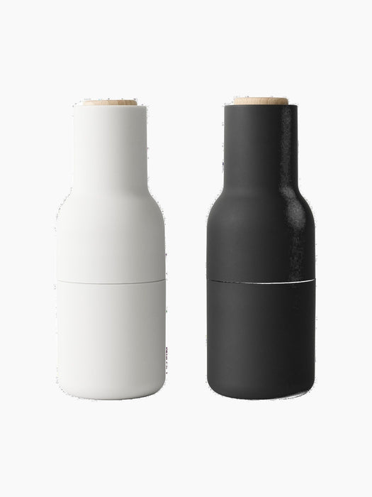 Two Bottle Grinders by Audo. The set includes one ash-coloured and one carbon-coloured grinder with a beech lid.