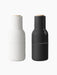 Two Bottle Grinders by Audo. The set includes one ash-coloured and one carbon-coloured grinder with a beech lid.