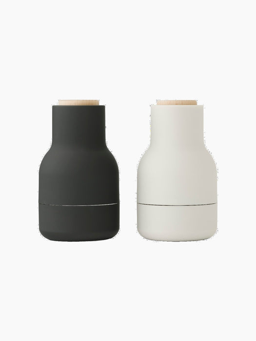 A pair of Audo CPH Bottle Grinders. One is matte carbon, the other matte ash, with beech lids.