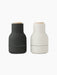 A pair of Audo CPH Bottle Grinders. One is matte carbon, the other matte ash, with beech lids.