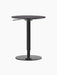 Back view of the height-adjustable Branch Side Table showing its round charcoal top, black steel pedestal, and circular base.