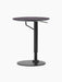 Angled view of the Branch Side Table, featuring a round charcoal linoleum top and a black height-adjustable steel base.