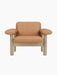 Front view of Brasilia Lounge Chair, Low Back, with a natural oak frame and camel leather upholstery, on a black background.
