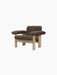 An angled view of the Brasilia Lounge Chair with a low back, featuring a natural oak frame and brown sheepskin upholstery.