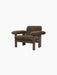 The Brasilia Lounge Chair, Low Back, in dark brown sheepskin with a dark wooden frame, shown from an angle.