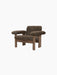 Front-angle view of the Brasilia Lounge Chair with a low back, featuring a dark wood frame and brown sheepskin upholstery.