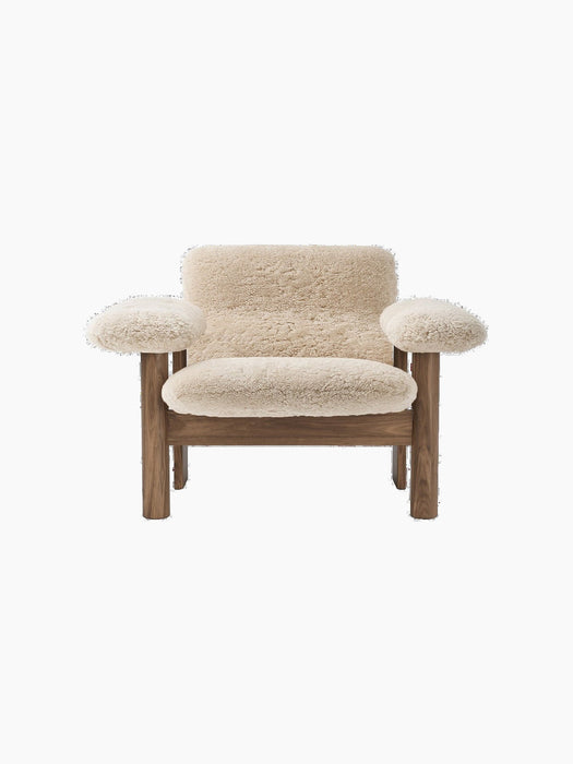 Front view of the Brasilia Lounge Chair, Low Back, Sheepskin, with a dark wood frame and cream sheepskin upholstery.