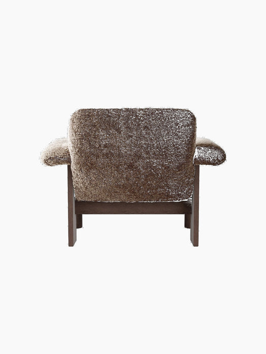 Back view of the Brasilia Lounge Chair, Low Back, upholstered in brown sheepskin with a dark solid wood frame.