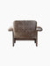 Back view of the Brasilia Lounge Chair, Low Back, upholstered in brown sheepskin with a dark solid wood frame.