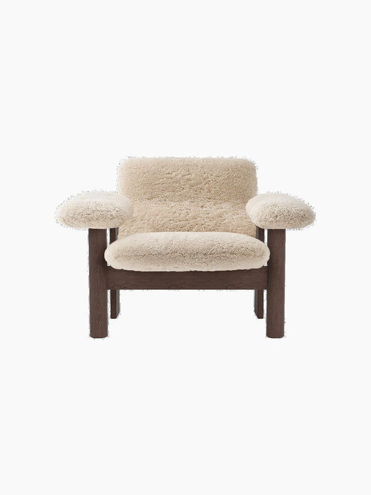 Front view of the Brasilia Lounge Chair, Low Back, with a dark oak frame and plush, off-white sheepskin upholstery.