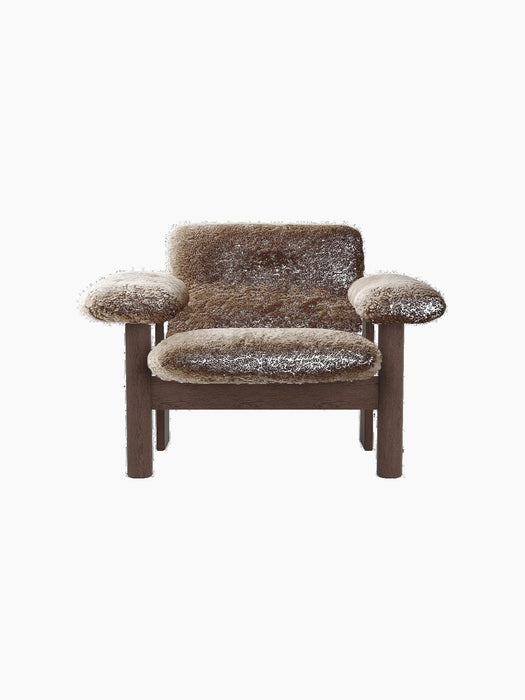 Front view of the Brasilia Lounge Chair, Low Back, upholstered in brown sheepskin with a dark stained oak frame.