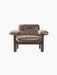 Front view of the Brasilia Lounge Chair, Low Back, upholstered in brown sheepskin with a dark stained oak frame.