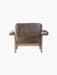 Back view of the Brasilia Lounge Chair with a low back, upholstered in dark brown sheepskin with a natural oak frame.