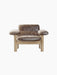 Front view of the Brasilia Lounge Chair, Low Back, with brown sheepskin and a light oak frame on a black background.