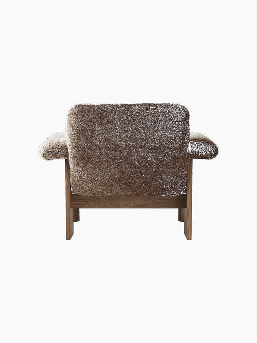 Back view of the Brasilia Lounge Chair, Low Back, upholstered in dark brown, textured sheepskin with a dark solid wood frame.