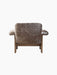 Back view of the Brasilia Lounge Chair, Low Back, upholstered in dark brown, textured sheepskin with a dark solid wood frame.