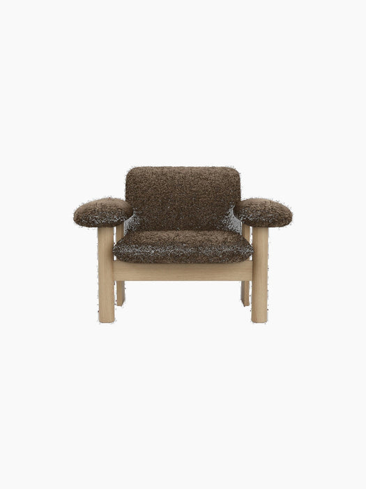 Front view of the Brasilia Lounge Chair, Low Back. The chair has a natural oak frame and dark brown Sheepskin Root upholstery