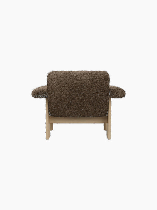 Back view of the Brasilia Lounge Chair, Low Back, upholstered in brown sheepskin, showing its natural oak wooden frame.