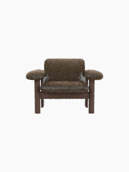 Front view of the Brasilia Lounge Chair, Low Back, in brown sheepskin with a dark stained oak frame on a black background.