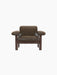 Front view of the Brasilia Lounge Chair, Low Back, in brown sheepskin with a dark stained oak frame on a black background.