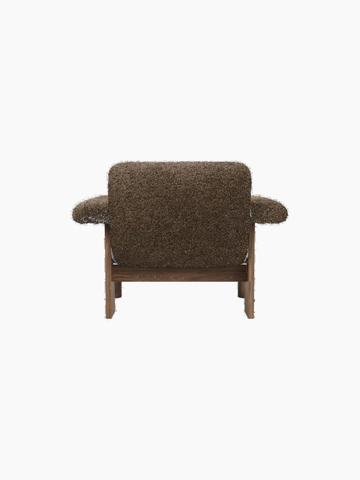 A back view of the Brasilia Lounge Chair with a low back, upholstered in brown sheepskin with a dark wooden frame.