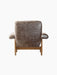Back view of the Brasilia Lounge Chair. High back and armrests in dark brown sheepskin on a natural oak frame.