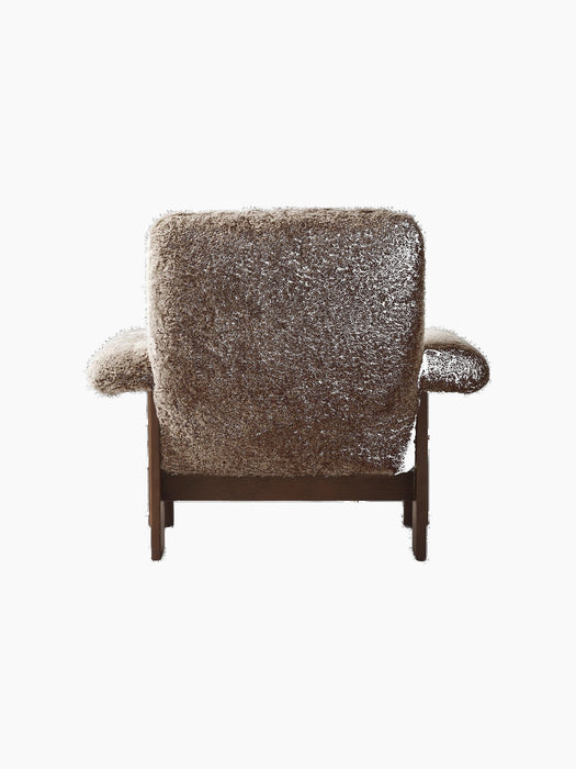 Back view of the Brasilia Lounge Chair, High Back. Dark stained oak frame with brown sheepskin upholstery.