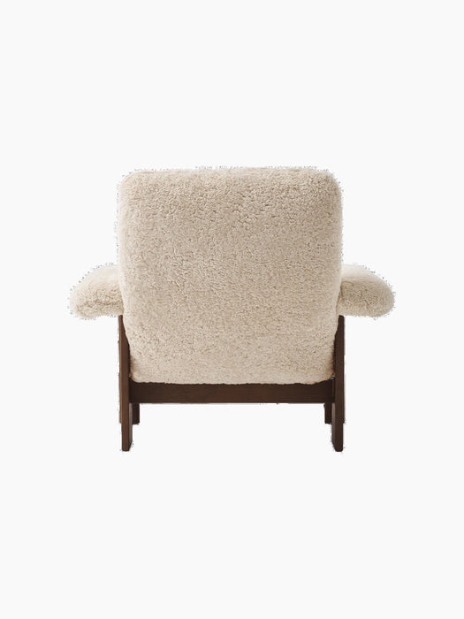 Back view of the Brasilia Lounge Chair, High Back, upholstered in cream sheepskin with a contrasting dark stained oak frame.
