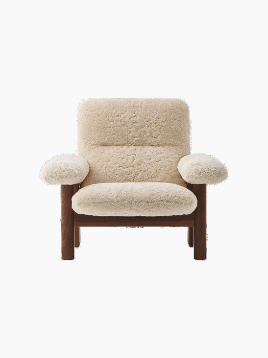 A front view of the Brasilia Lounge Chair with a high back, dark stained oak frame and thick, plush sheepskin upholstery.