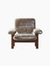 Front-on photograph of the Brasilia Lounge Chair with a high back, upholstered in plush brown sheepskin on a dark oak frame.