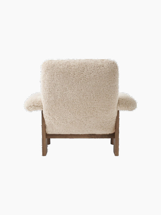 Back view of the Brasilia Lounge Chair, High Back, featuring cream sheepskin upholstery on a dark walnut frame.