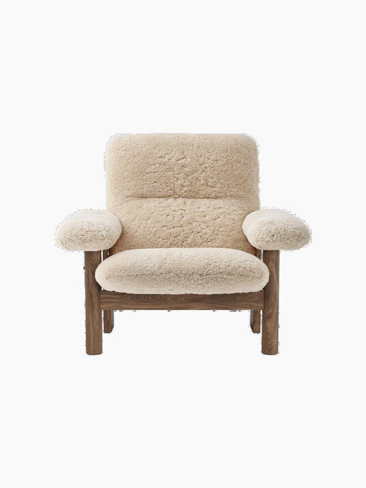 Front view of the Brasilia Lounge Chair, High Back, Sheepskin. With a dark wood frame and plush cream sheepskin upholstery.