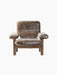 The Brasilia Lounge Chair, High Back, shown front-on. It has a dark wood frame and is upholstered in plush, brown sheepskin.