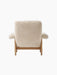 Rear view of the Brasilia Lounge Chair, upholstered in fluffy Sheepskin Nature fabric with a sturdy Natural Oak wooden frame.