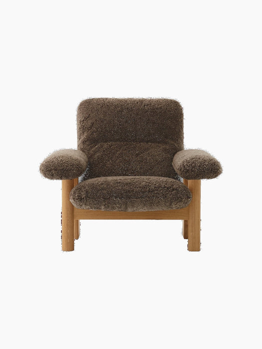 Front view of the Brasilia Lounge Chair. Natural oak frame with plush, high-backed upholstery in dark brown sheepskin.